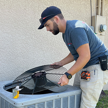 Man Servicing AC Unit in Cape Coral Florida